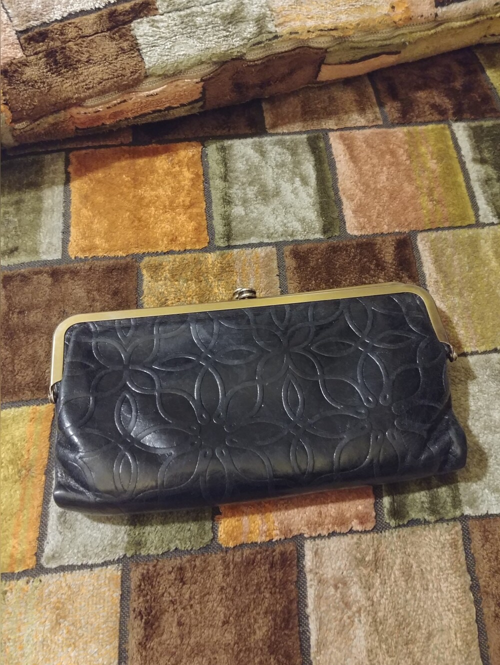 Hobo Black Floral-Embossed Leather Clutch with Gold Trim